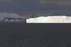 Iceberg highlighted by sunlight.